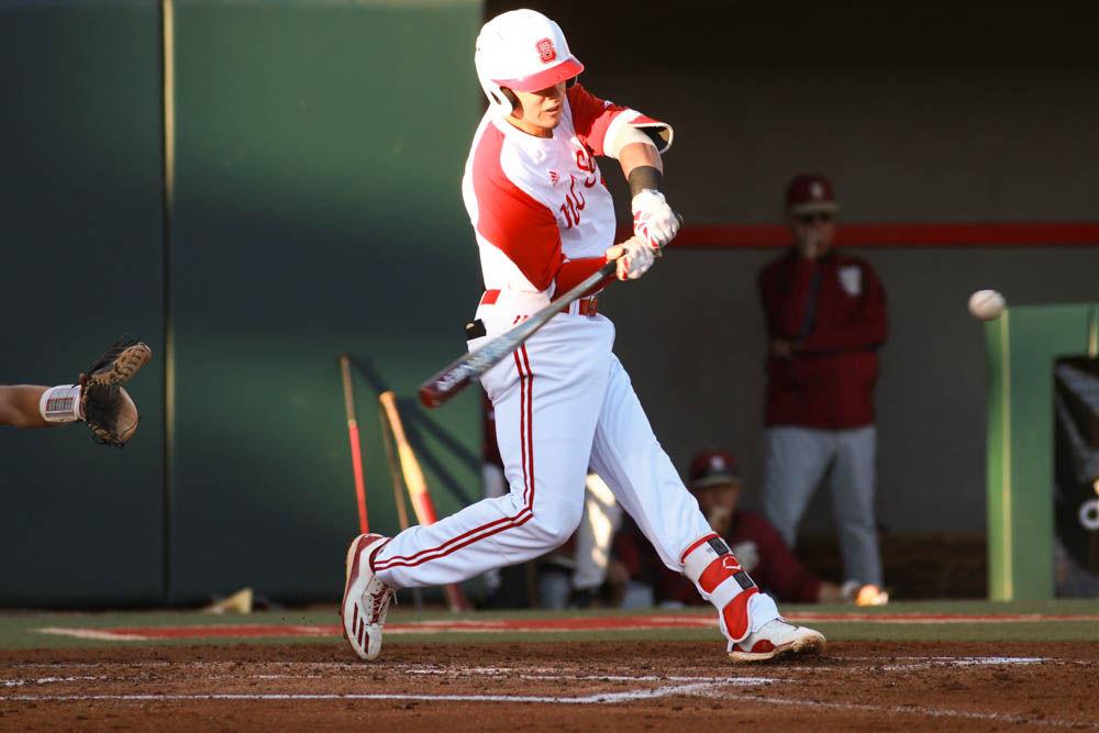 Junior third baseman Evan Mendoza crushes a pitch that sailed for a home run in the Wolfpack's game against Florida State on April, 8 2017 at Doak Field.