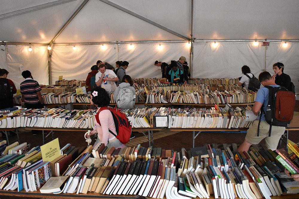 Students, faculty and staff hunt for books during the Frank B. Memorial Book Sale in the Brickyard on Wednesday. All the books were donated and collected throughout the year from students, faculty and alumni. The Book Sale offers a wide variety of book genres, from thriller, to sports, to engineering. All proceeds of the Book Sale go to the NC State libraries to benefit students and faculty. The Book Sale is named after Frank B. Armstrong, who supported and donated to NC State. Last year, the Book Sale raised more than $15,000 and sold about 800 books.