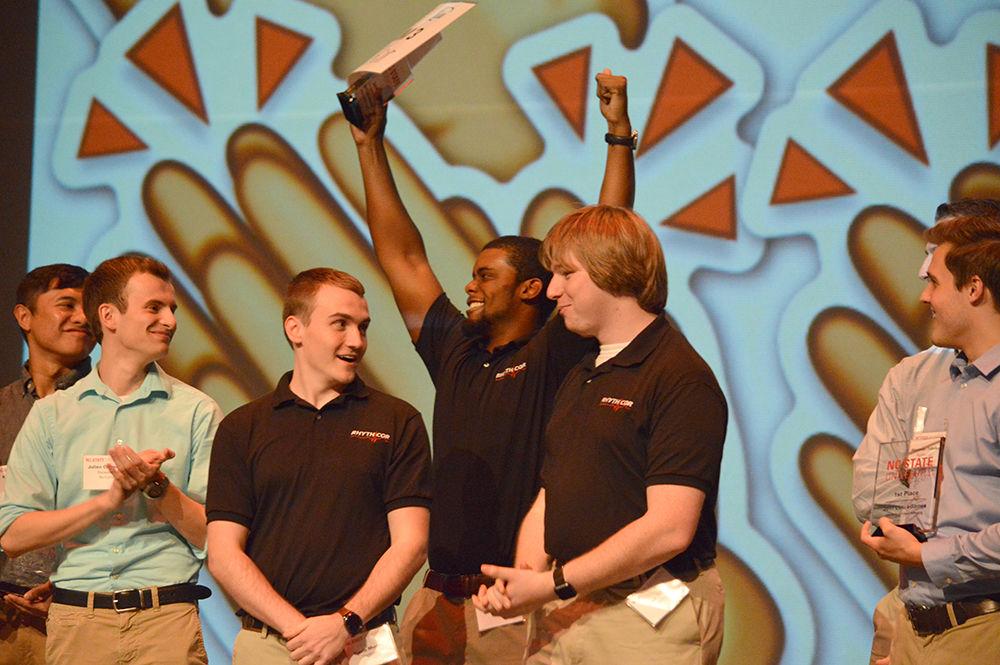 Travis Murray, a senior studying computer engineering, Brian Graham, a senior studying mechanical engineering and Jack Dodd, a senior studying electrical engineering, celebrate being voted the audience favorite during the LuLu eGames Award Ceremony in Stewart Theatre on Thursday. Rhythcor developed PulseAware, a device that aims to combat heart attacks suffered by firefighters by monitoring their heart, detecting signs of a heart attack, and alerting emergency services when necessary. Rhythcor won awards in several categories.