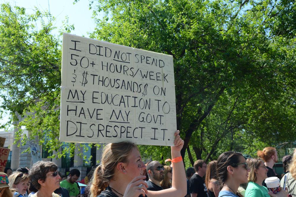 A marcher's sign reads "I did not spend 50+ hours a week and thousands on my education to have my government disrespect it," a sentiment echoed by many others that participated in the first ever Raleigh March for Science. The Raleigh march was one of over 500 sister marches that were held across the globe on Earth Day, April 22, 2017 and hundreds of thousands of individuals the world over came out to protest the state of public policy towards science.