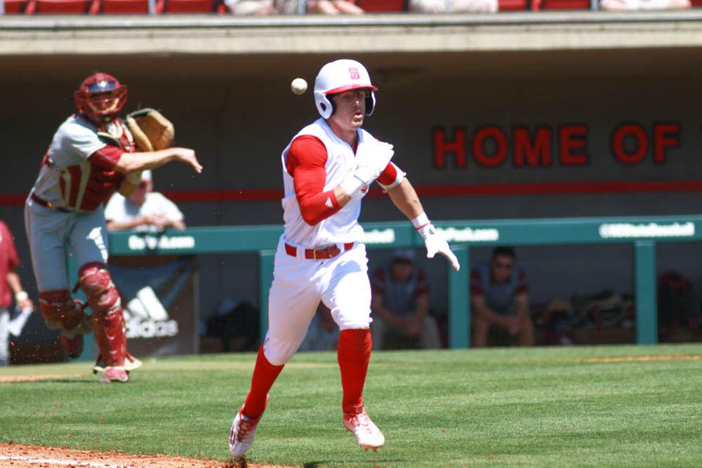 Junior center fielder Josh McLain sprints down the third base line as Florida State catcher Cal Raleigh picks up the bunted ball and throws it to first base for the out in the Wolfpack's 8-4 win on April 9, 2017 at Doak Field.