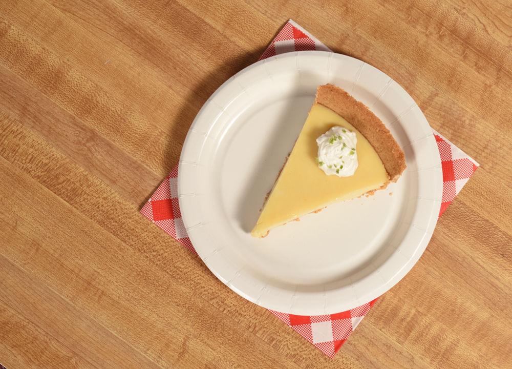 Garnish key lime pie with Cool Whip and lime zest. Make sure to use authentic key limes for an extra tart treat.