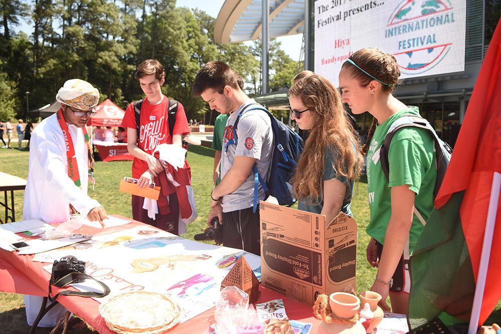 Sultan Al-Ismaili, a sophomore studying chemical engineering, tells a group of students about his home country Oman during the International Festival at Stafford Commons on Friday. The International Festival, sponsored by Student Involvement, Student Government, the Multicultural Student Affairs Office and the Office of International Services, gave students the opportunity to learn about different cultures around the world.