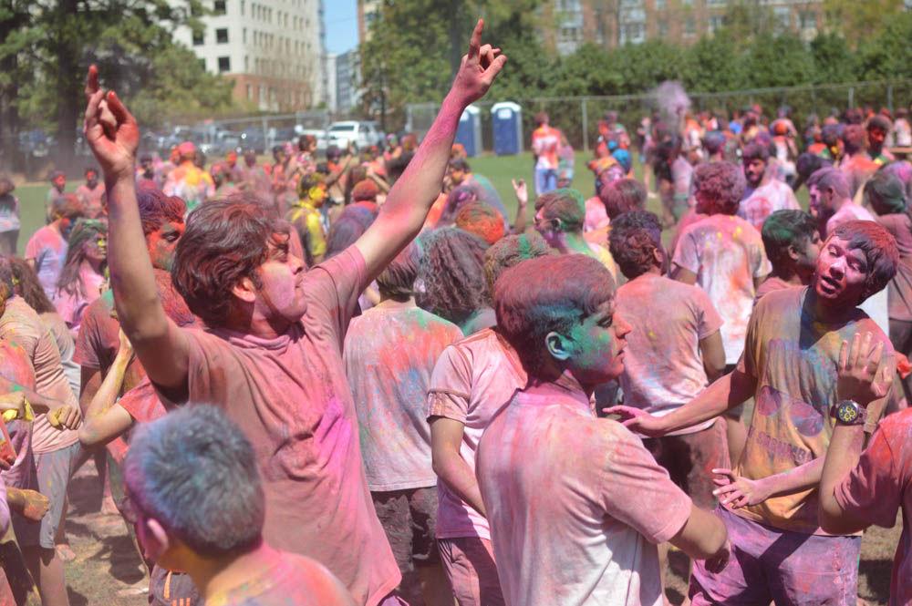 Participants dance and throw colors during the Holi Festival on Lee Fields, Sunday, April 2, 2017. Holi is a Hindu spring festival of colors typically celebrated in India and Nepal. Holi is hosted by Ektaa, Maitri at NCSU, Delta Sigma Iota, and Multicultural Student Affairs.