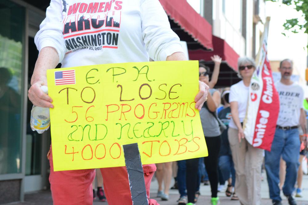 Many signs, including this one that reads "EPA to lose 56 programs and nearly 4000 jobs," criticized the Trump's administration actions regarding the environment and science, in this case specifically the proposed budget cuts to the Environmental Protection Agency. Thousands of citizens came out to the Raleigh March for Science held on April 22, 2017 in support of science and to protest these federal actions.
