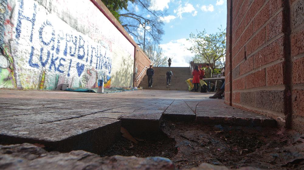 A hole created by missing bricks sits outside the Free Expression Tunnel on March 14. Holes like this one pop up across the campus due to students taking bricks as keepsakes and the gaps in the walkways can sometimes grow to be rather large.&#160; Stealing a brick, while not an official tradition of the university, is a well-known practice among students.