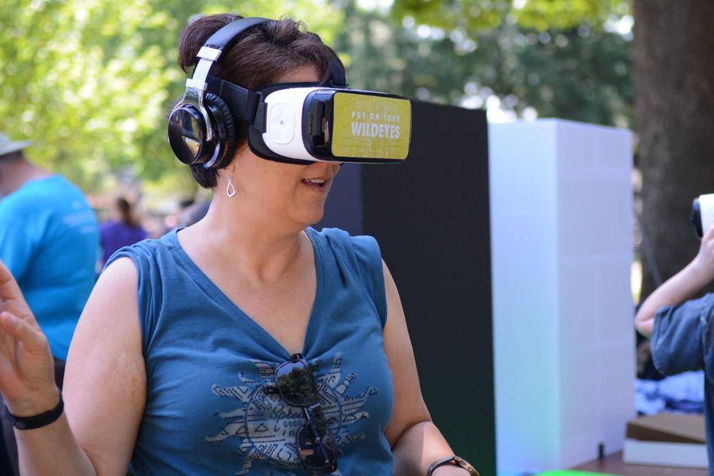 Mina Harris from Cary, NC experiences a virtual reality version of multiple national parks at the community science fair held at the first Raleigh March for Science on April 22, 2016. Harris missed the step off of the march and instead jumped into the crowd as it made its way through downtown. This was not her first march, as she previously participated in the Women's March held in January.