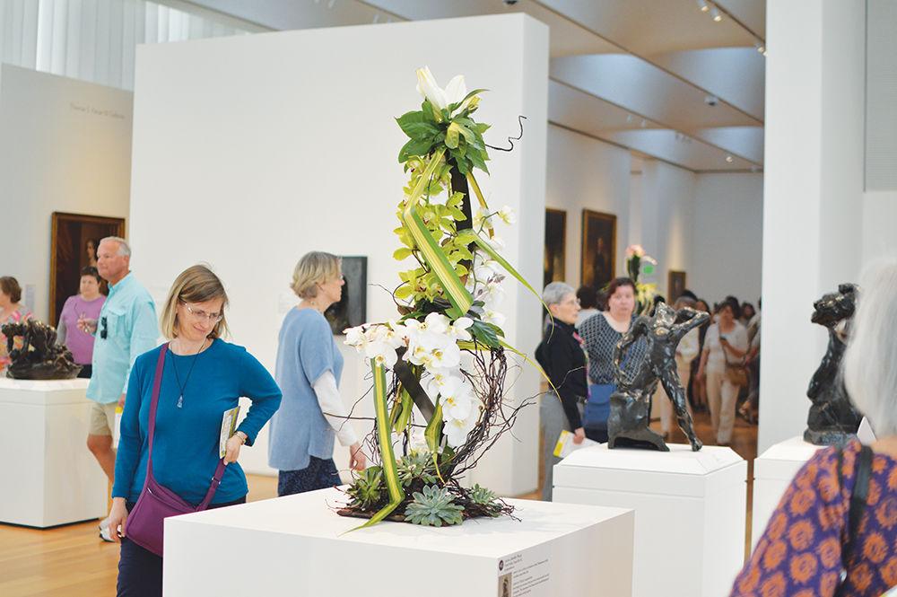 Attendees look at installation art as part of the third annual &#8220;Art in Bloom&#8221; event at the North Carolina Museum of Art on Saturday. &#8220;Art in Bloom,&#8221; presented by PNC, ran from Thursday through Sunday. The four-day festival included a park tour, a floral jewelry workshop and a botanical couture headpieces master class, as well as many other featured workshops.