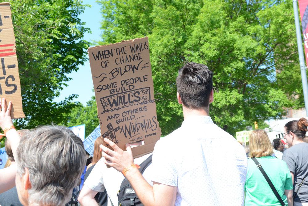A sign reading "when the winds of change blow some people build walls and others build windmills" was one of the many that criticized, either directly or indirectly, the current federal administration and its stance on the environment and science. Thousands of marchers at the Raleigh March for Science expressed their frustrations on April 22, 2017 through chants and these signs.