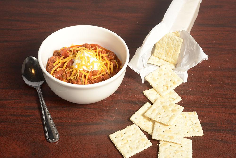 Garnish a hearty serving of chili with a dollop of sour cream and shredded cheddar cheese.