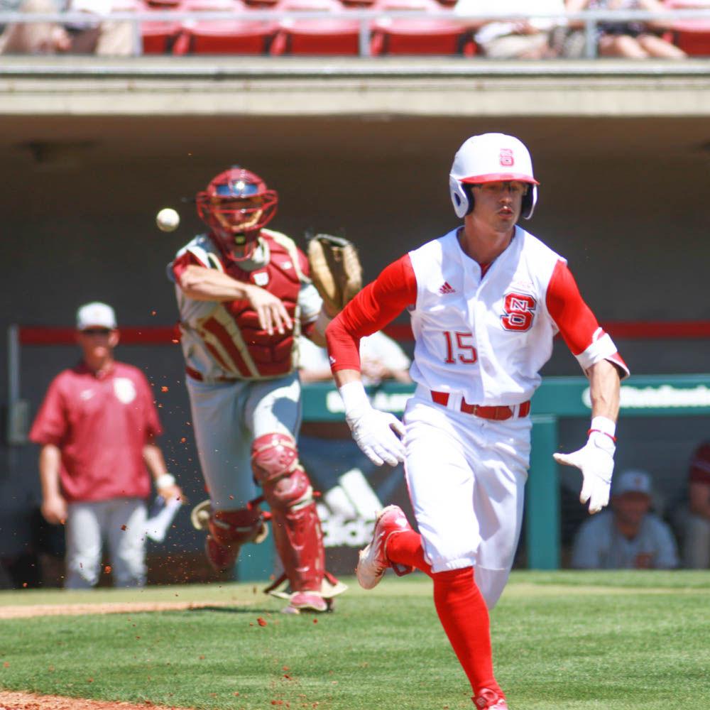 Junior center fielder Josh McLain sprints down the third base line as Florida State catcher Cal Raleigh picks up the bunted ball and throws it to first base for the out in the Wolfpack's 8-4 win on April 9, 2017 at Doak Field.