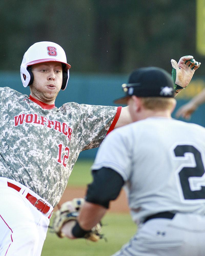 Freshman designated hitter Brad Debo slides into third base and beats the throw in the Wolfpack's game against Campbell on March 21. Debo had two hits and one RBI in five at-bats in the 9-8 loss at Doak Field.