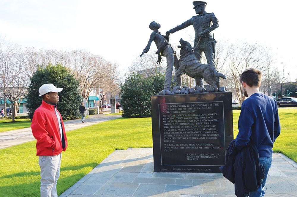 Malik Majette, a senior studying computer science, and Shawn Riley, a junior studying electrical engineering, reads a monument dedicated to activists who participated in the American civil rights movement. The monument is part of Kelly Ingram Park in Birmingham, Alabama.