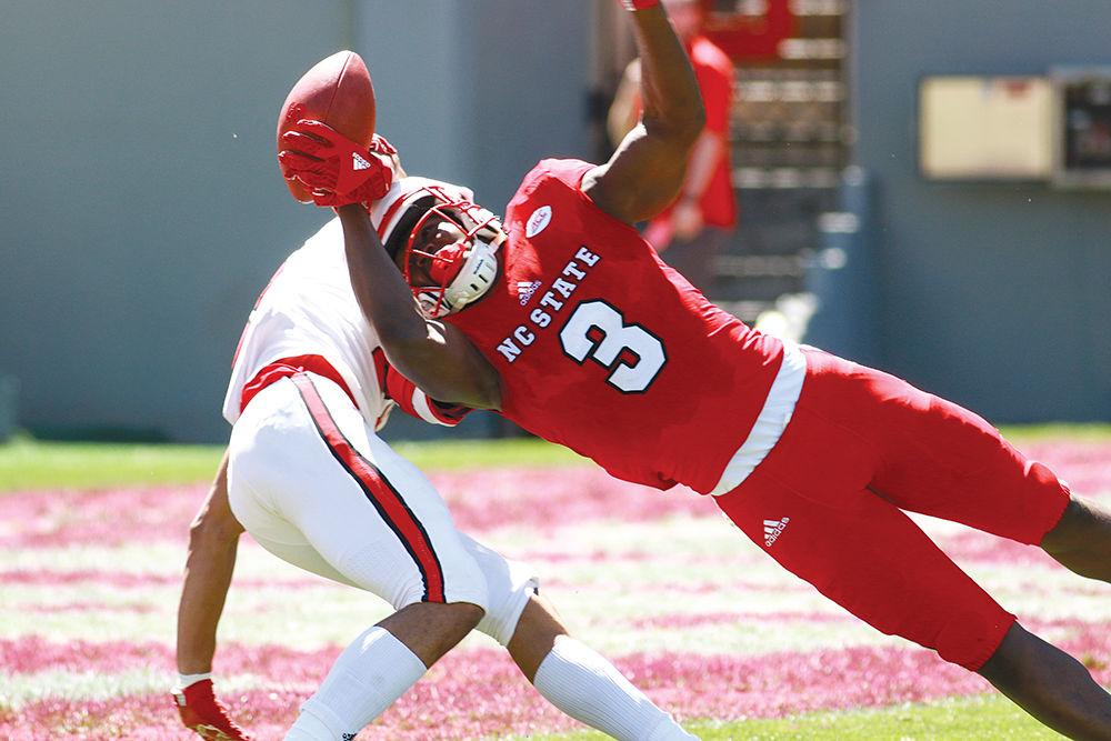 Sophomore wide receiver Kelvin Harmon fights for possession of the ball midair with sophomore corner back Nick McCloud in the Wolfpack's Kay Yow Spring Game on Saturday at Carter-Finley Stadium. The format of this year's Spring Game was completely changed, featuring scripted plays and no live tackling.