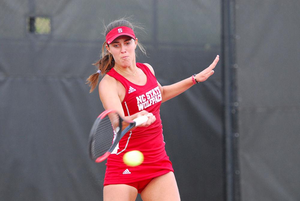 Freshman Adriana Reami returns a ball to opponent Fernanda Navarro at the N.C. State vs Clemson University tennis match at J.W. Isenhour Tennis Center on Fri. Mar. 31st, 2017. Reami won her match against opponent Navarro after two sets scoring 7-5 and 6-3 respectively. The Wolfpack won over Clemson 6-1 raising their season to a 15-7 win-loss record.