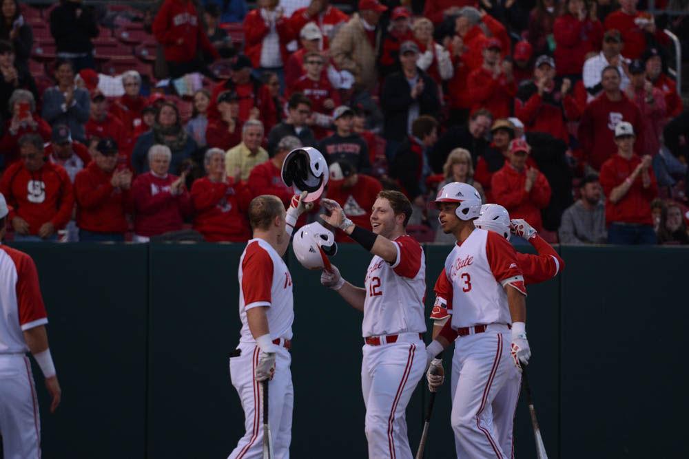 Freshmen center Brad Debo celebrates with his teammates after scoring a homerun against Florida State on April 8, 2017. Wolfpack won 8-4 at Doak Field.