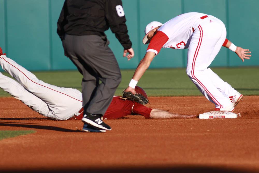 Junior short stop Joe Dunand tags out a Florida State runner at second base as he dives back to the bag in their game on April 8, 2017 at Doak Field.
