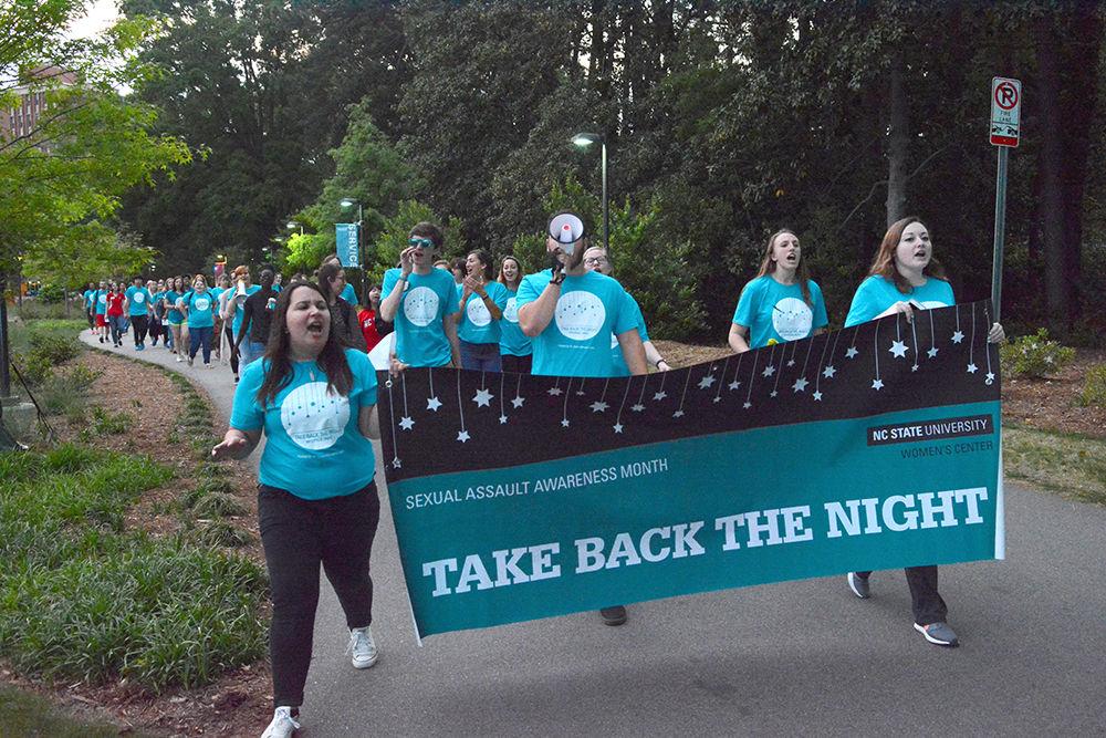 Students march through Stafford Commons as a part of the Take Back the Night event on Wednesday. The event was started to help put a stop to rape culture and to address issues of sexual violence on campus.