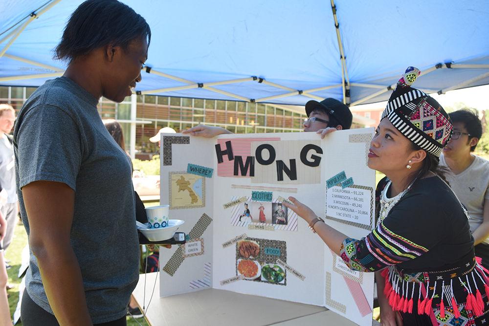 Crystal Thao, a junior studying business administration tells Cole Koffi, a senior studying civil engineering, about the Hmong people from southeast Asia during the International Festival at Stafford Commons Friday. The International Festival, sponsored by Student Involvement, Student Government, the Multicultural Student Affairs Office and the Office of International Services, gave students the opportunity to learn about different cultures around the world.