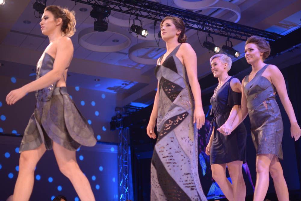 Laura Wyker, a senior studying art and design, joins her models for their final walk during Art2Wear on Friday. Wyker's line, called "Imposteria," meant to mimic a moth's tactics of deception through patterns and texture.