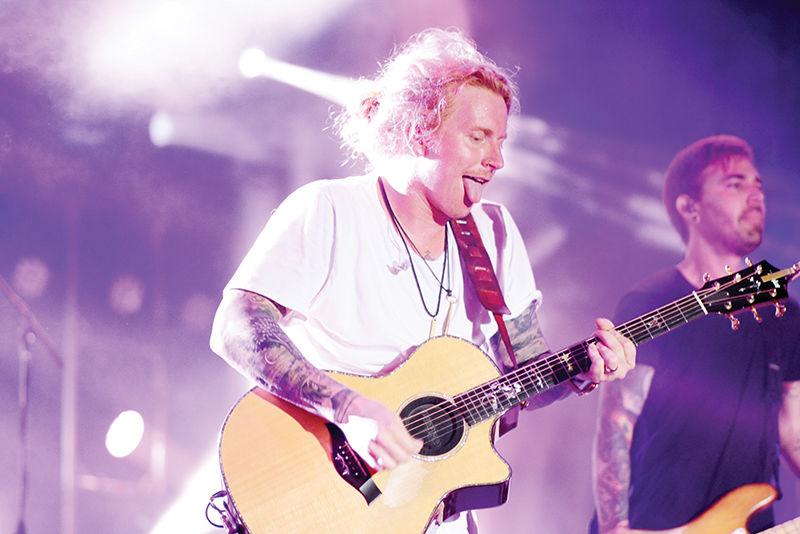 Travis Clark, the lead singer of We the Kings, performs for a crowd during the band&#8217;s headline concert for Packapalooza on Aug. 20. The performance capped off the all-day block party on Hillsborough Street, which is the final event of Wolfpack Welcome Week. The annual festival drew roughly 60,000 people in 2016.