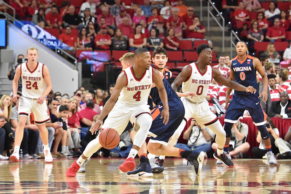 Freshman guard Dennis Smith Jr. weaves through the Virginia defense in PNC Arena on Feb. 25. Smith contributed 13 points to the Wolfpack total. Virginia defeated NC State 70-55.