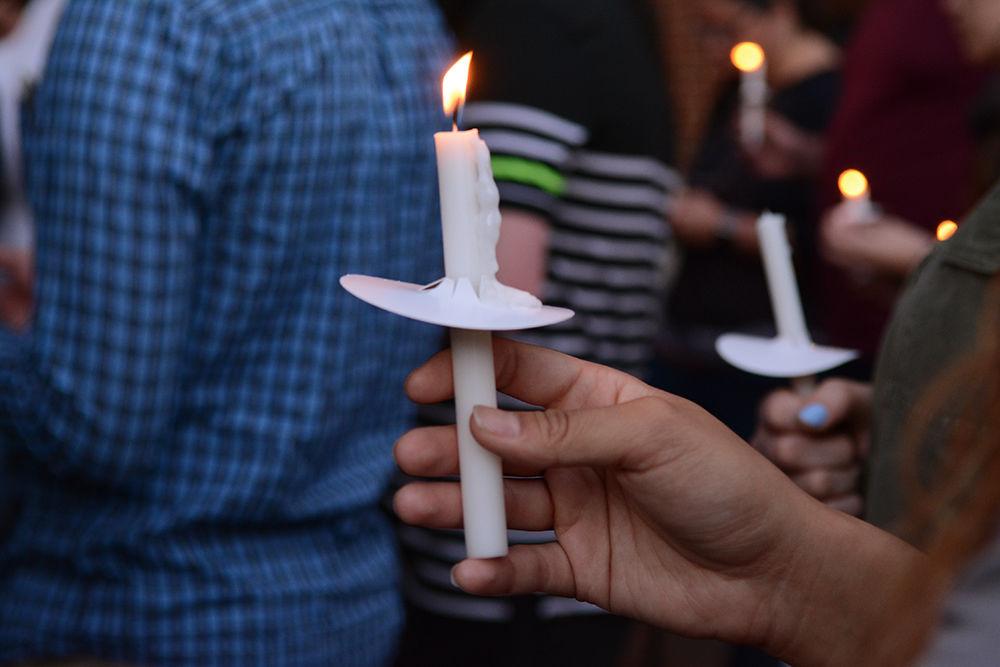 A student holds a candle in remembrance of Cheyanne Hass, a senior who was studying electrical engineering, who passed away early Sunday due to a car accident. A vigil was held for Hass at Engineering Buiding II on Centennial Campus on Monday and students, faculty and others came out to honor the memory of and speak about Hass.