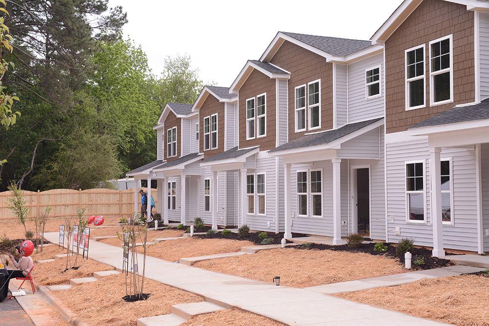 The eleven townhomes built as a part of Habitat for Humanity's Build-A-Block project were dedicated on Saturday, May 6, 2017 at the dedication and celebration ceremony held at the Lake Wheeler site. In addition to the five homes already completed, two of the final six homes were fully finished, while construction on the last four will continue into the summer, after which the families can move in.