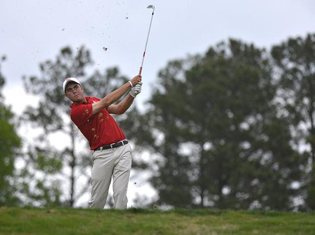Sophomore Jacob McBride drives the 17th hole at the Wolfpack Spring Open Sunday afternoon. McBride finished -2 and the Wolfpack won the tournament with a score of -17 at Lonnie Poole Golf Course on April 19, 2015.