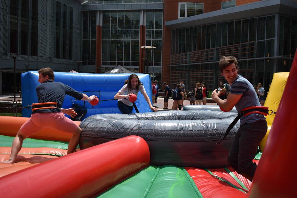 Jacob Michel, a junior studying chemistry, Tara Janelli, a senior studying chemistry and Joe Weiner, a senior studying chemistry, compete in a game of life size Hungry Hippos at Stafford Commons on April 28. This game, along with a handful of other activities, was open for everyone to celebrate the last day of classes.