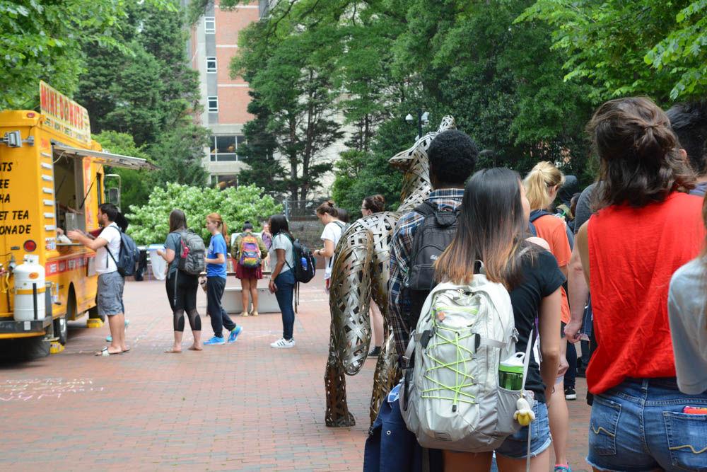 Students wait in line for donuts from the Dusty Donuts food truck in Wolf Plaza on April 28. Food trucks like Dusty Donuts were on campus as part of the LDOC or last day of classes festivities. Students were able to get free food when showing their LDOC voucher to the business.