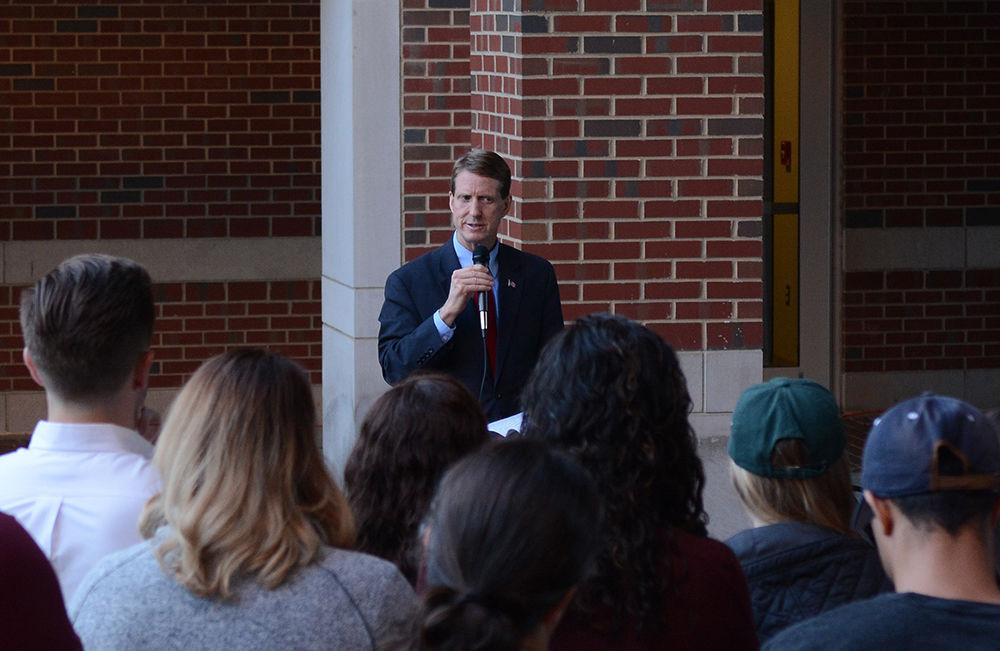 Jerome Lavelle, associate dean of academic affairs in the College of Engineering, speaks to a small crowd of friends, family and others who came to a candlelight vigil held at Engineering Building II on Monday. The vigil was held to honor and remember Cheyanne Hass, senior who was studying electrical engineering, who passed away Sunday after a car accident. Lavelle, as well as other faculty members and students, offered their condolences and spoke about the outstanding student and friend Hass was.