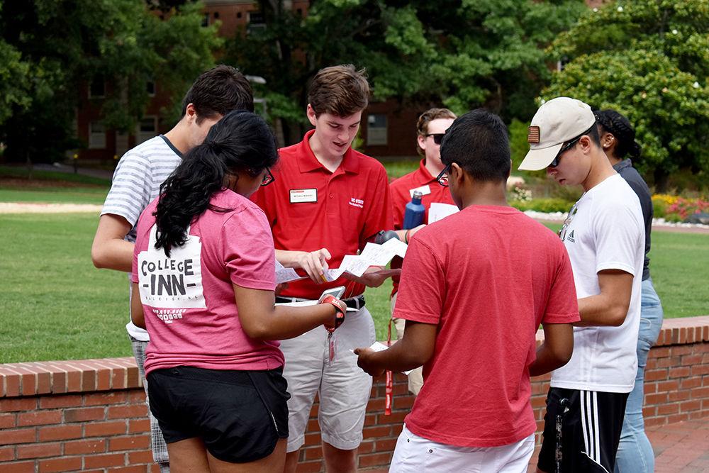 Peer mentor Mitchell Moravec helps Summer START participants navigate through campus using an NC State campus map. Moravec was one of the many peer mentors who gave a tour to students during the Wolfpack Wondering event on Sunday, June 25. The event allowed students to see the buildings that their classes will be held in during summer session II.
