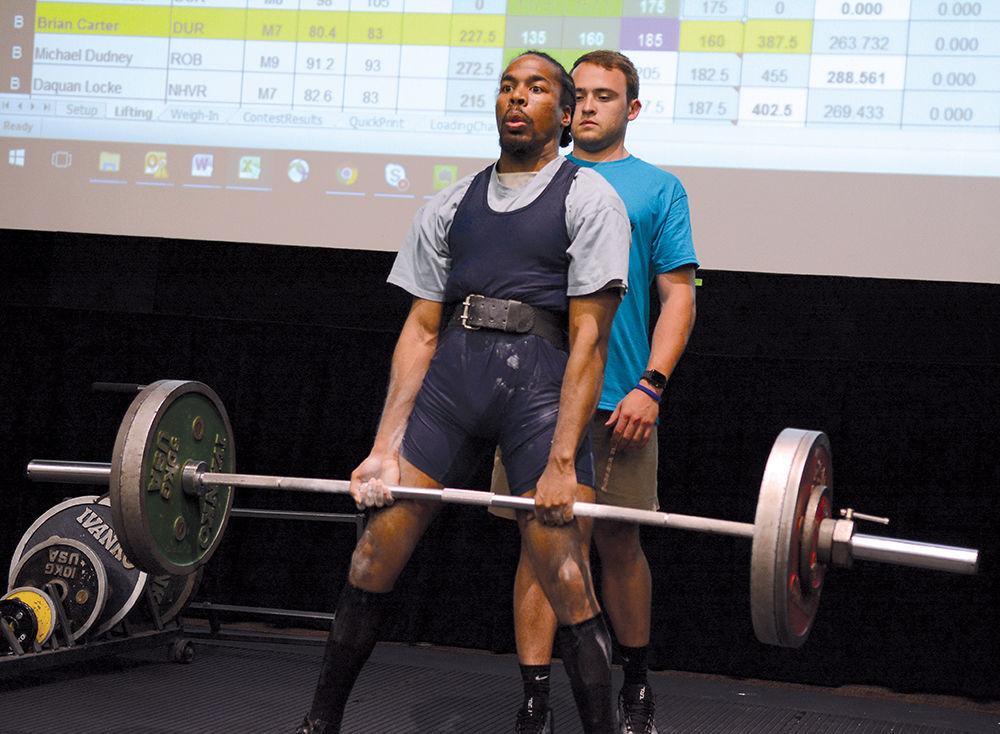 Brian Carter from Durham County lifts a heavy weight with a volunteer behind him during the triple combo competition in the powerlifing event in the Witherspoon Cinema as part of the Special Olympics Saturday, Jun 3 2017. Powerlifting was among several events taking place on campus during the Special Olympics Summer Games. The Olympics allow those with disabilities across North Carolina the chance to compete in various sporting events.