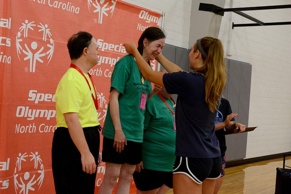 Estella Vacher from Vance County gets emotional as she receives a gold medal for volleyball skills from UNC Chapel Hill volleyball player Julia Scoles during the award ceremony as part of the Special Olympics at Carmichael Gymnasium Saturday, Jun 3 2017. Volleyball was among several events taking place on campus during the Special Olympics Summer Games. The Olympics allow those with disabilities across North Carolina the chance to compete in various sporting events.