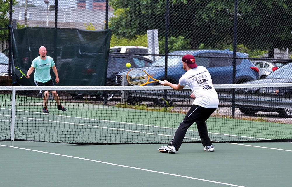 Bran Holland and Michael Park compete in a doubles match at William Peace Tennis Courts on Saturday, June 17. Holland won the match 6-4 for his team Baby got Backhand. &#8220;Stonewall Sports is a fantastic way to dip your toes into the water if you are new to the area or just curious about being more involved in the LGBTQIA community,&#8221; Holland said.