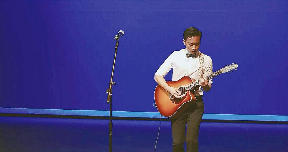 Emanuel Lirag plays guitar in Stewart Theatre.