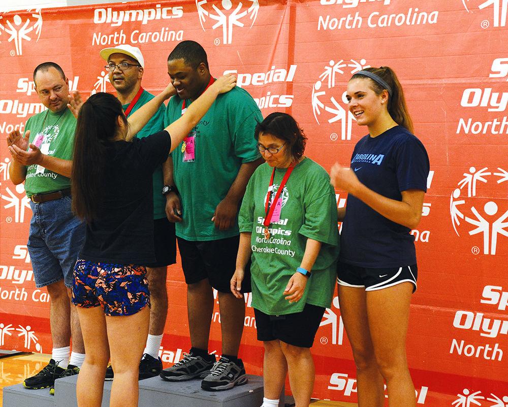 Christopher Morton from Vance County receives a gold medal for volleyball skills for his division from UNC Chapel Hill volleyball player Mia Fradenburg during the award ceremony at Carmichael Gymnasium as part of the Special Olympics Saturday, Jun 3 2017. Volleyball was among several events taking place on campus during the Special Olympics Summer Games. The Olympics allow those with disabilities across North Carolina the chance to compete in various sporting events.