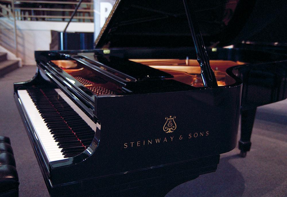 A Steinway and Sons piano played by Keith Jarrett, Diana Krall, Mccoy Tyner, David Benoit, Lang Lang, Emanuel Ax, and Yefim Bronfman stands in exhibition on the showroom floor of the Hopper Piano Company in Raleigh, NC on Wednesday, July 5. The piano exhibition is part of the "Living Legends Tour" hosted by Steinway and Sons. In the showcase are three pianos played by famous artists including Billy Joel and many more.
