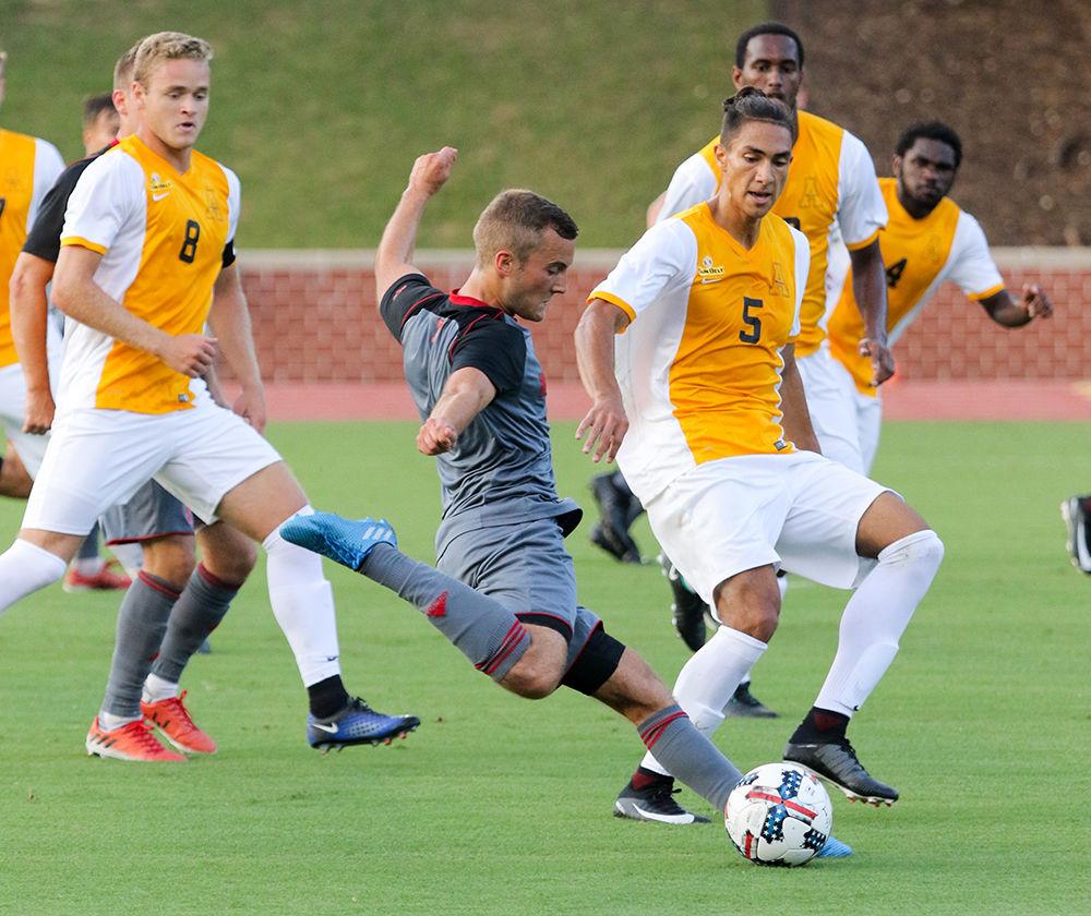 Senior midfielder Julius Duchscherer kicks the ball into the 18-yard box on an attempted assist during the exhibition game against Appalachian State on August 13, 2017 in Dail Soccer Stadium.