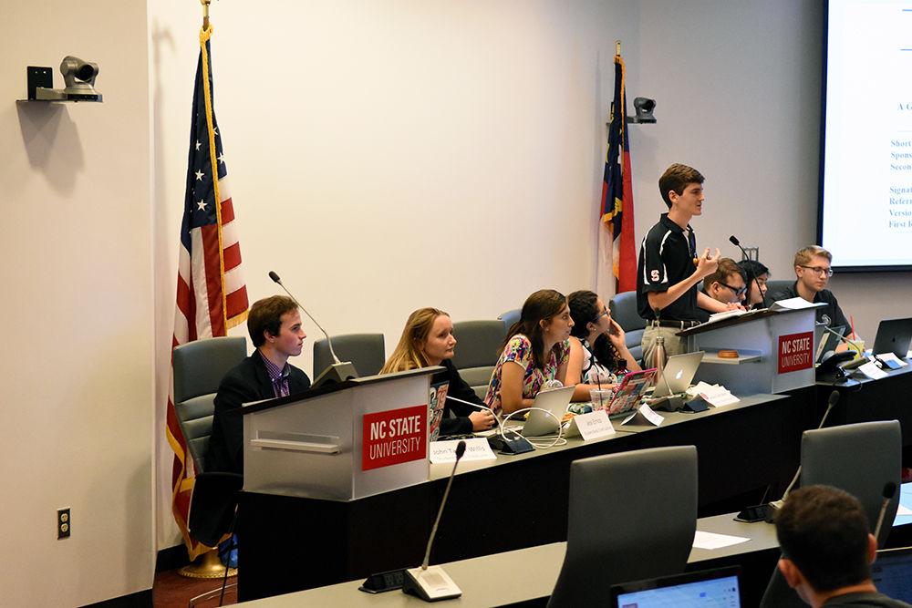 Student Body Treasurer John Taylor Willis, a third-year studying business administration, looks straight ahead, as Mitchell Moravec, a fifth-year studying psychology and materials science and engineering, reads off Willis' impeachment charges.