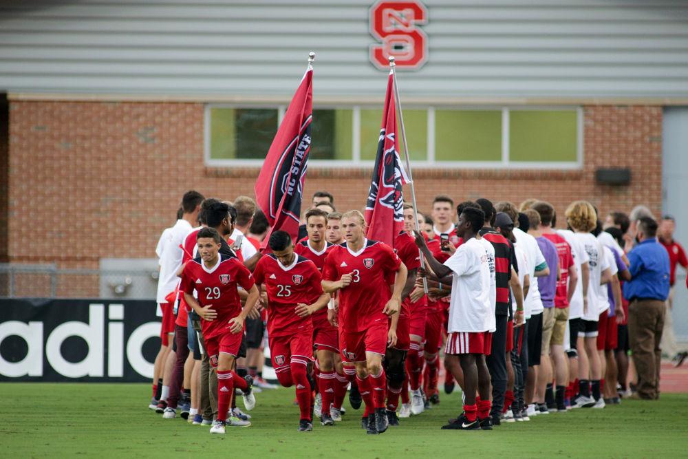 The men's soccer team takes the field through the Red Terrors fan tunnel on Friday, Aug 25. Th Wolfpack took down Florida Atlantic 3-2 in Dail Soccer Stadium.