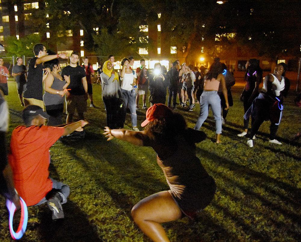 A group of students dance to music at WolfPack After Dark on Lee Field on Friday, Aug. 25. The Inter Resident Council and University Activites Board contracted Montrell Davis, known as DJ Trellz, for the event. Students were provided with food, games and giveaways.