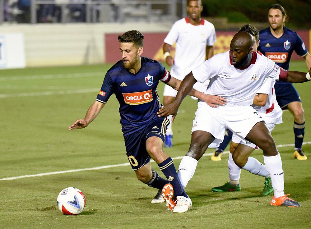 Nazmi Albadawi, a former NC State Soccer player and current defender for North Carolina FC, evades an opponent during a game in June 2017.