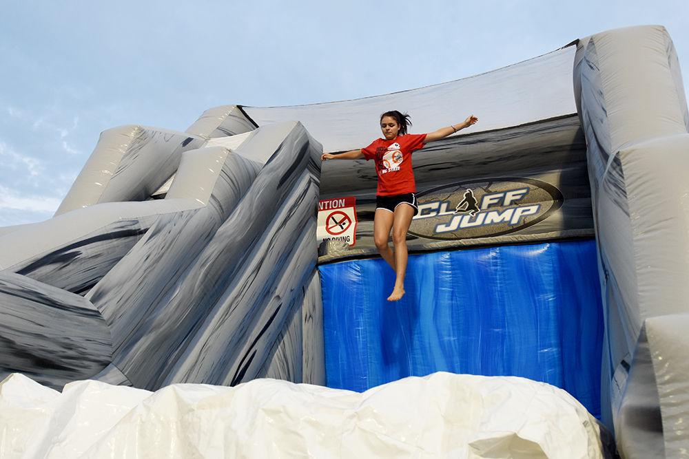 Victoria Augoustides, a first-year studying exploratory studies, hops off an inflatable cliff at this year's RecFest on Sunday on Miller Fields.