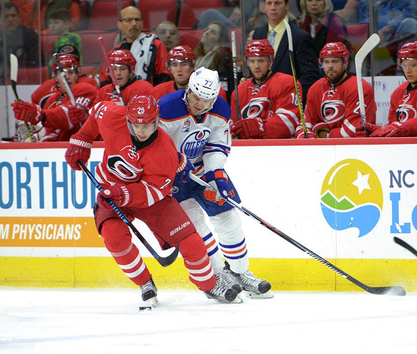 Hurricanes forward Sebastian Aho fights the puck off of Oilers defender Oscar Klefbom. The Hurricanes defeated the Oilers 2-1 in PNC Arena on Feb. 3 with goals from Aho and forward Elias Lindholm.&#160;