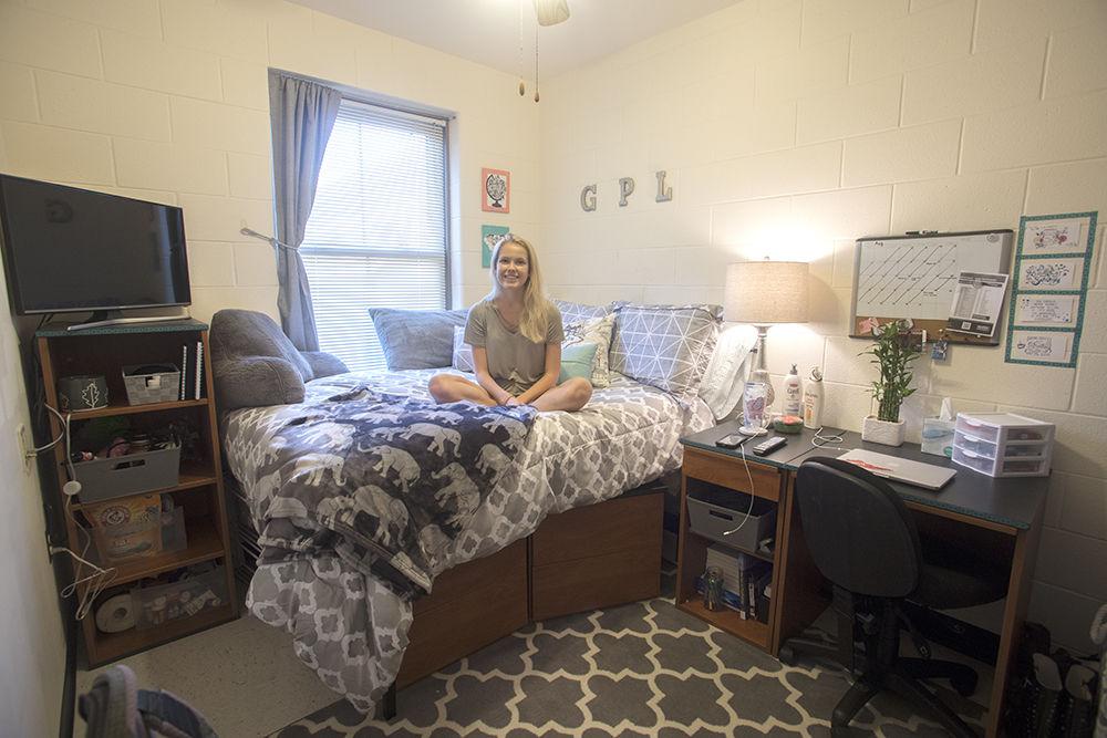 Gabrielle Lewis a second-year studying biological sciences sits in her apartment in Wolf Village on Friday Aug. 25. Lewis was worried that the things she put on the wall wouldn&#8217;t come off easily, so she focused on the rest of the decor instead. Lewis won the Wolf Den Design challenge in the Best Apartment category.