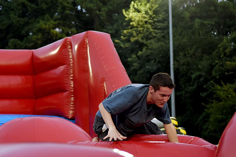 John Rizzo a first-year studying communications grabs on to a ball for dear life during a Big Baller game at this year's RecFest on Sunday, August 13 on Miller Field. Rizzo said his inspiration to play this game came from watching the show 'Wipeout.'