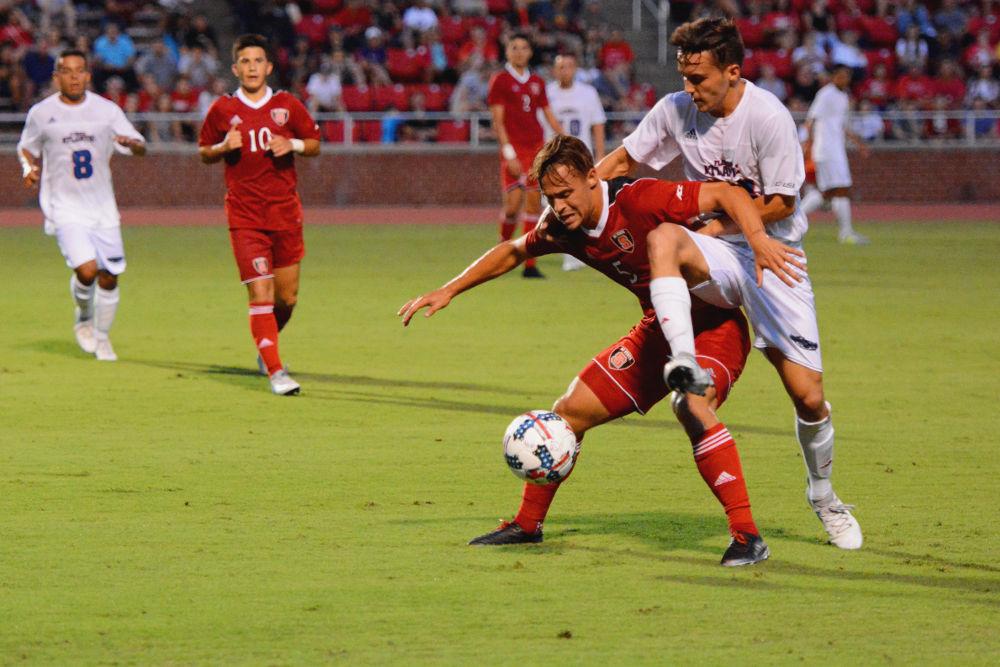 Junior forward Stephen Elias defends possession against the Florida Atlantic Owls. The Wolfpack would go on to win the game by a score of 3-2 in Dail Soccer Stadium on Friday, Aug 25.