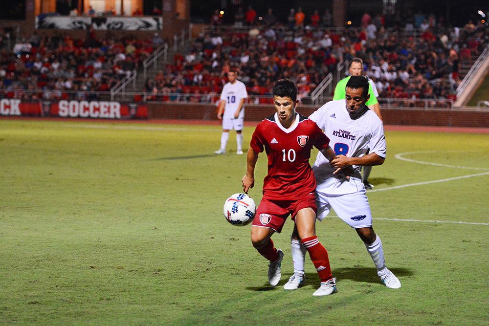Freshman forward David Loera fights for a free ball against Florida Atlantic. NC State won against the Owls 3-2 in Dail Soccer Stadium on Friday, Aug 25.